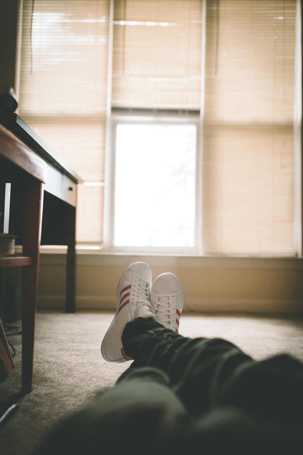 person on floor beside desk