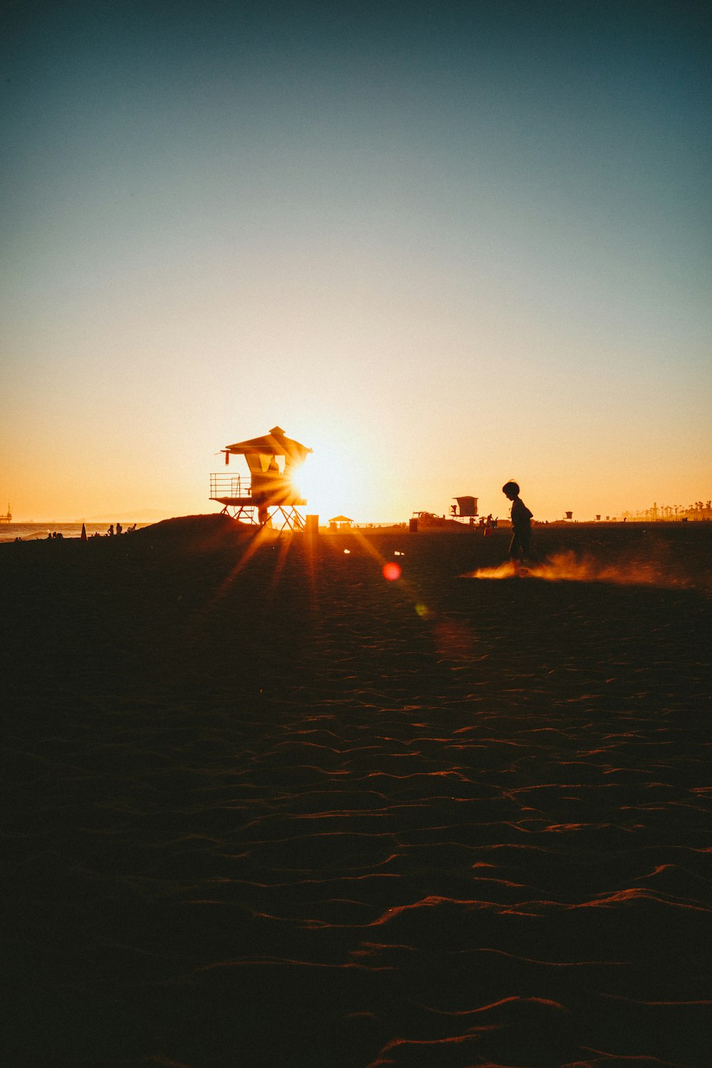 silhouette of people standing on field during sunset