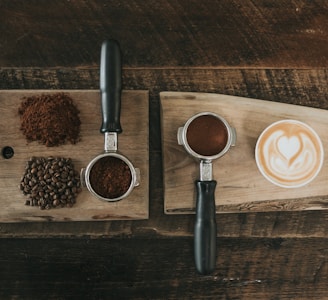 coffee beans beside coffee powder on brown wooden board