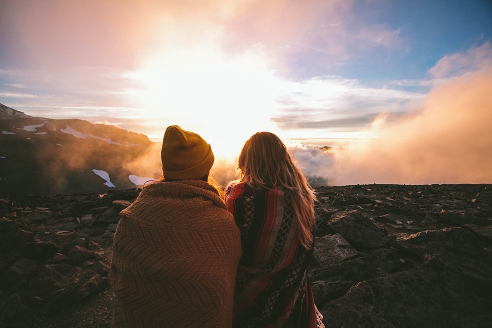 man and woman under clear blue sky during sunrise