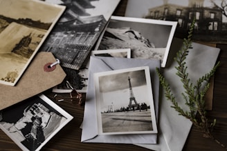 grayscale photo of Eiffel tower on top of white envelope