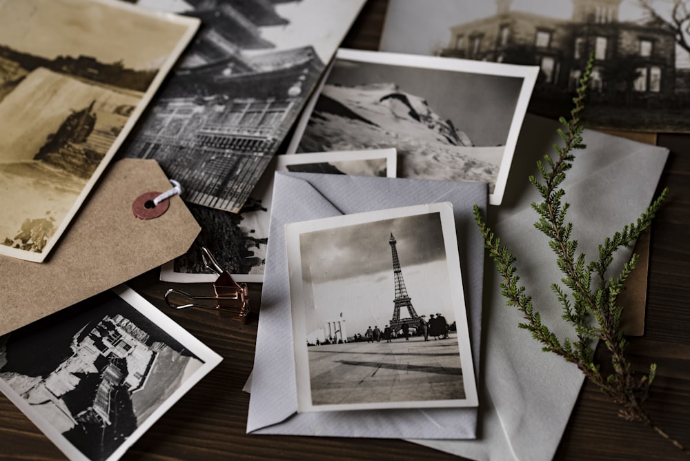 grayscale photo of Eiffel tower on top of white envelope