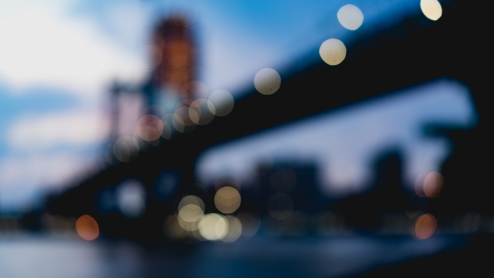 bokeh photography of suspension bridge