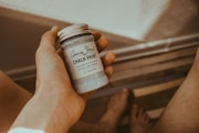 person's hand holding Chalk Paint bottle