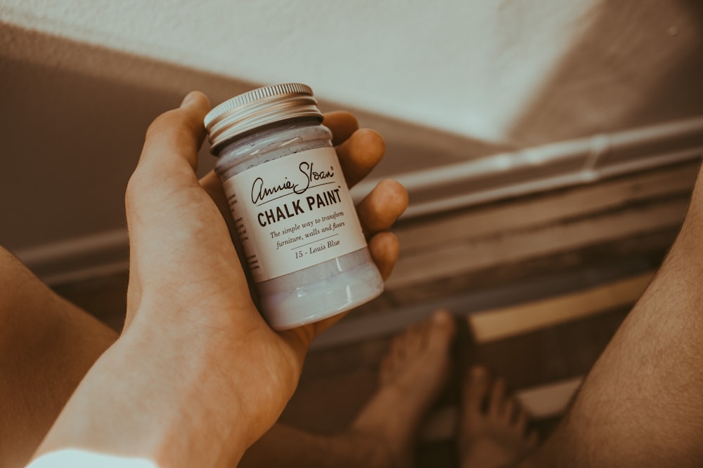 person's hand holding Chalk Paint bottle