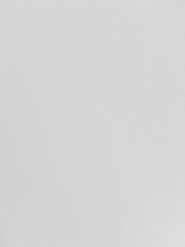 A plain white surface with a smooth texture.