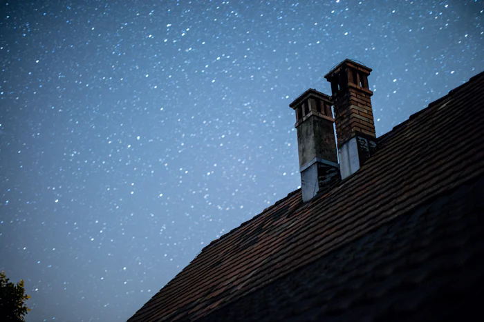 Cozy home at night with an active chimney