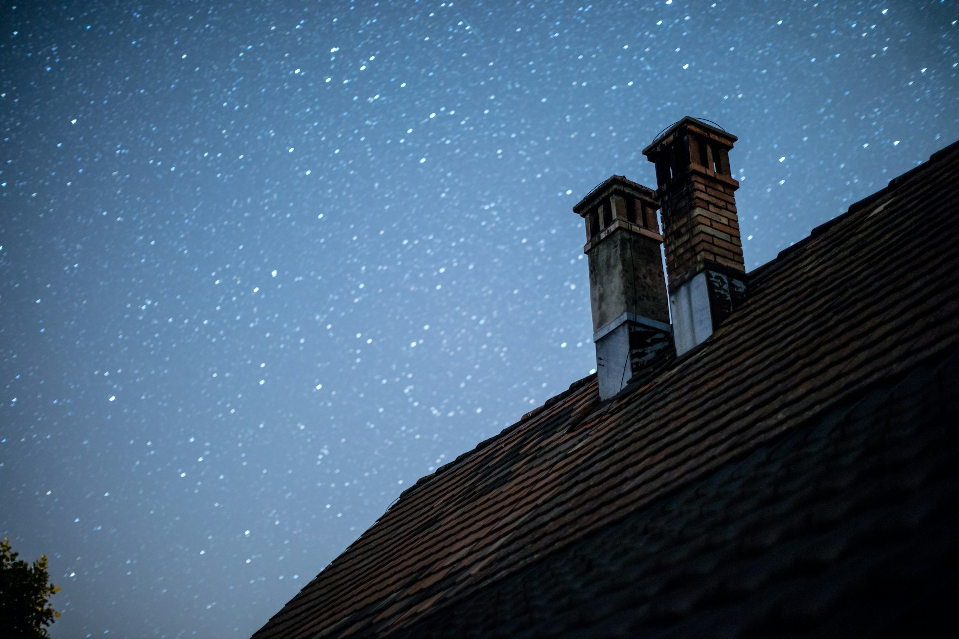 brown and black wooden house under starry night