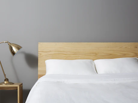 Modern bedroom setup showcasing a minimalist decoration kit with bedding and lamps