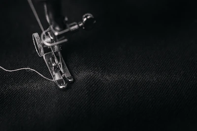 Close-up of hands sewing a garment made from natural, eco-friendly fabric.