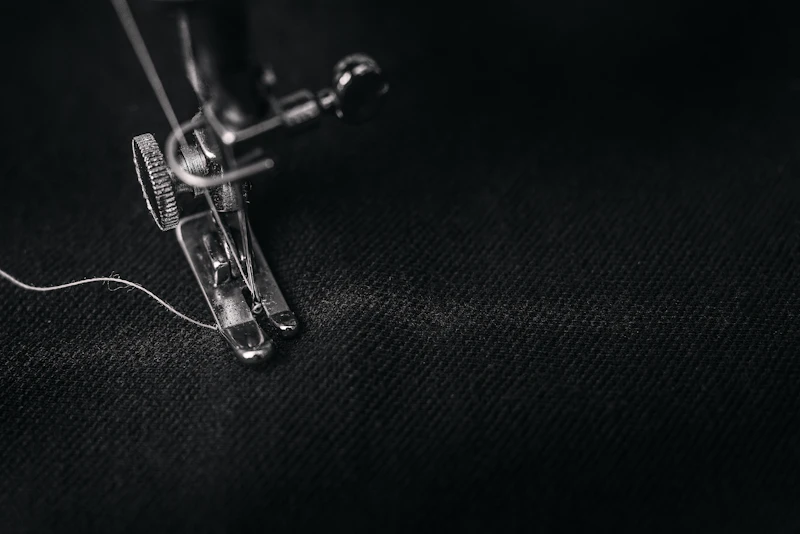 Sewing machine close-up with thread on fabric — finishing