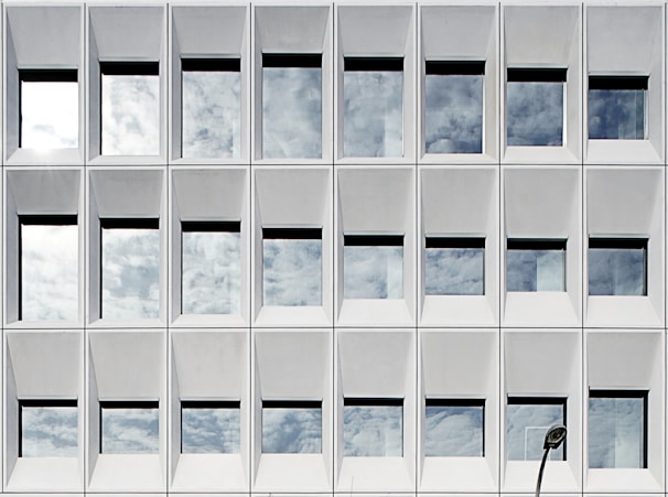 Aluminum window with a matte finish reflecting the sunlight in an urban setting.