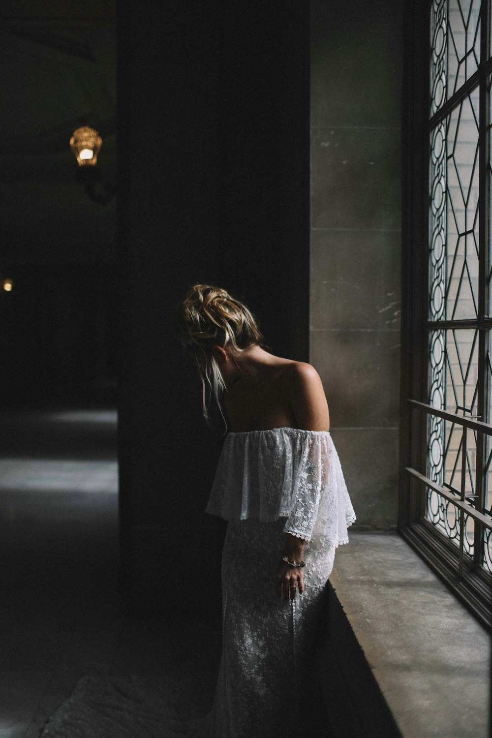 woman standing beside window