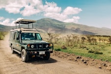 black jeep wrangler on dirt road during daytime