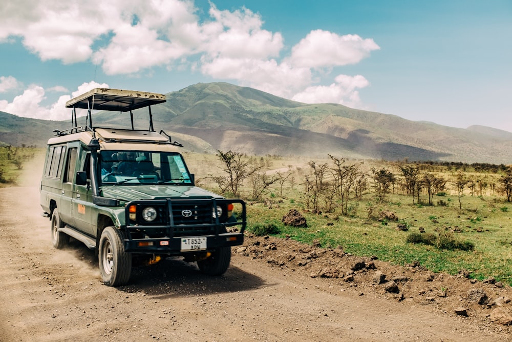 black jeep wrangler on dirt road during daytime