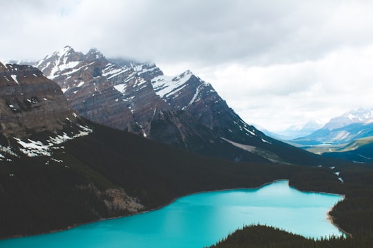 body of water by mountains during daytime in Banff National Park Canada