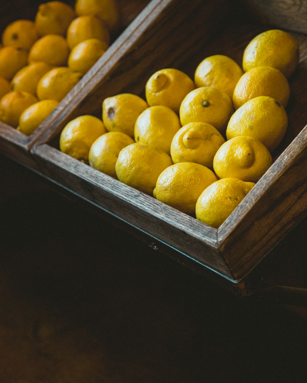bunch of lemons on wooden rack