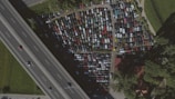 Aerial view of a busy parking lot with cars entering and exiting