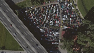 Aerial view of a busy parking area with cars.