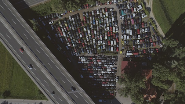 Aerial view of a busy parking area with cars.
