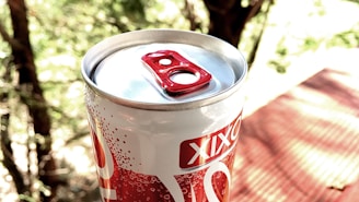 A close-up of Amethyst Beverage cans on a picnic table.