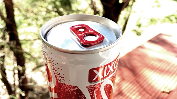 A close-up of Amethyst Beverage cans on a picnic table.
