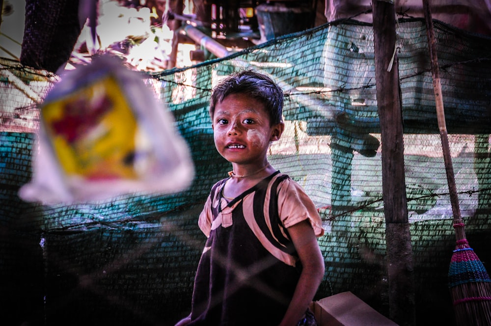 selective focus photography of toddler inside mesh net