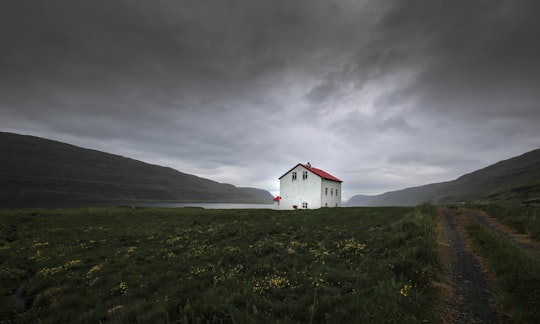 architectural photography of red and white house in Westfjords Region Iceland