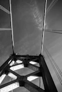 Monochrome image of a large suspension bridge highlighting structural details.