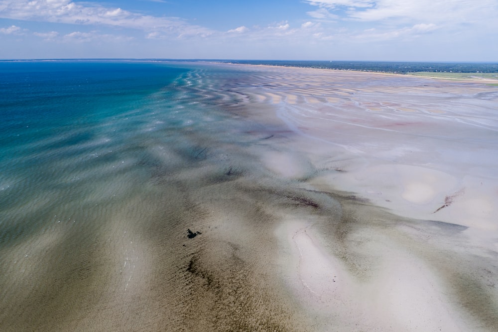 landscape photography of seashore under cloudy sky