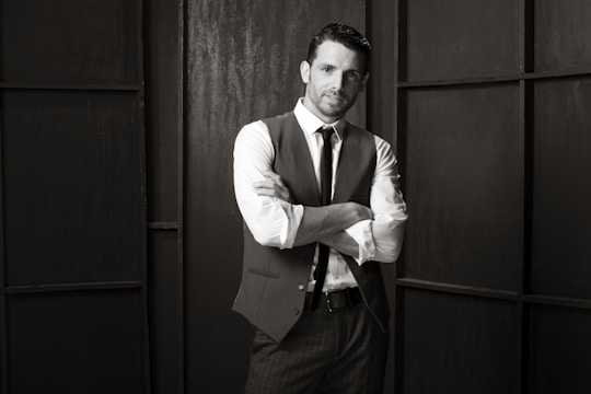 A sleek black and white photo of a confident influencer showcasing a high-end grooming product.