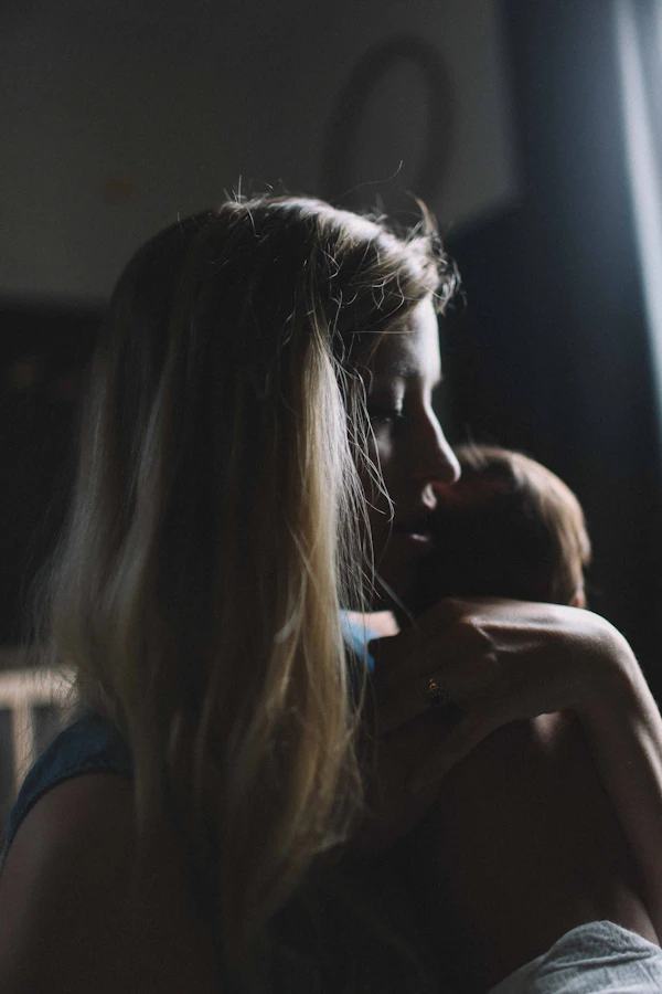Woman carrying and caring for a baby
