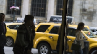 A group of people getting into a taxi.