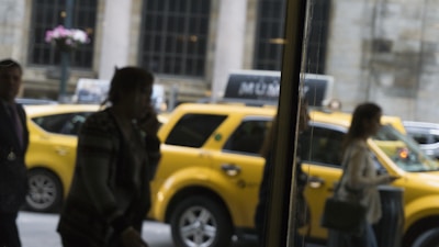 A group of people getting into a taxi.
