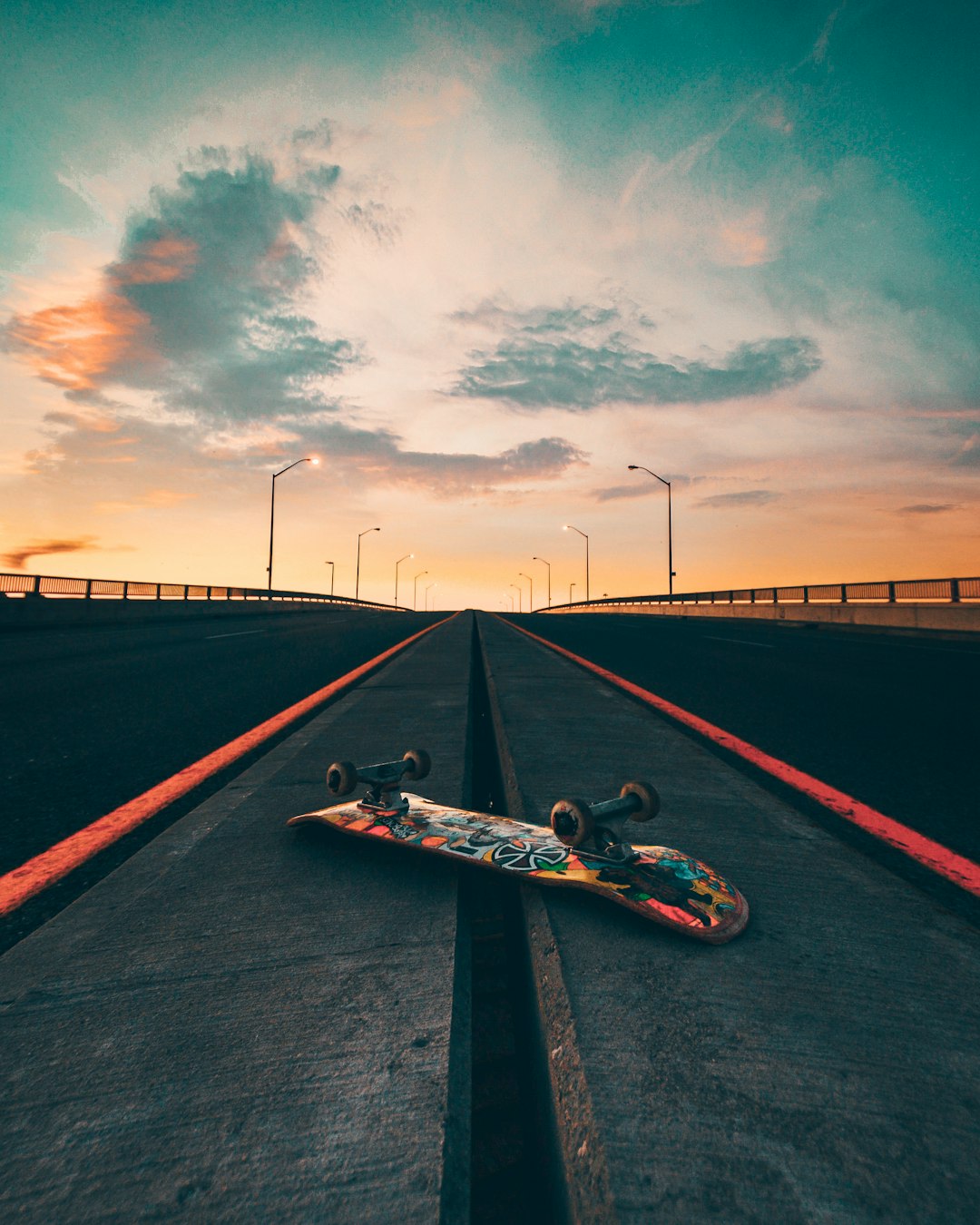 black skateboard on black asphalt road under gray cloudy sky during daytime