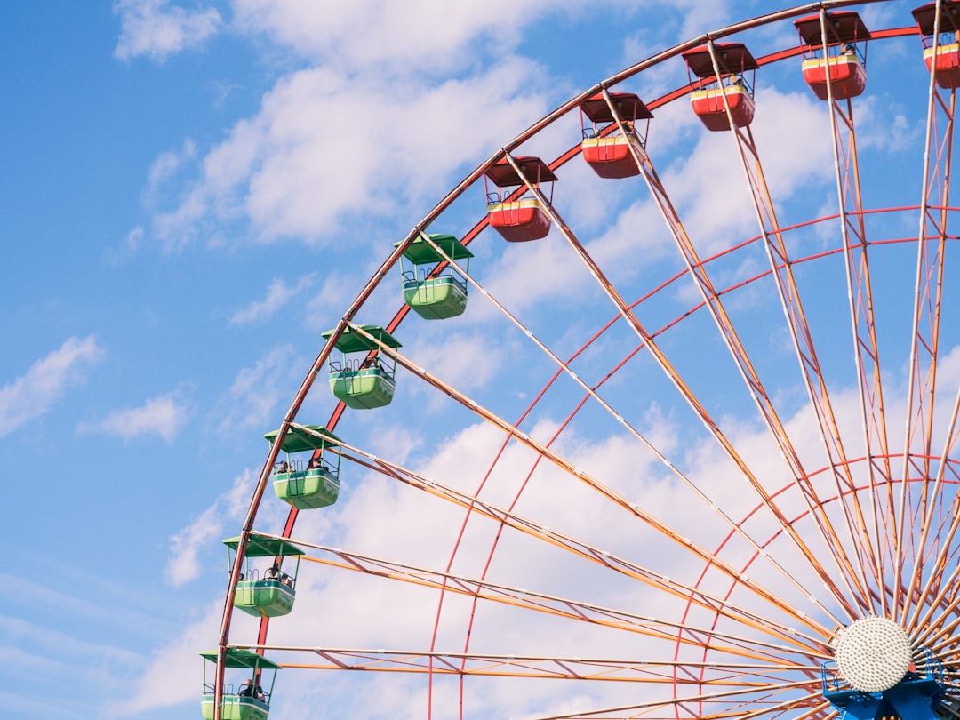 Ferris wheel under cloudy sky during daytime