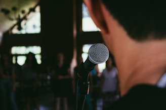 man standing in front of microphone