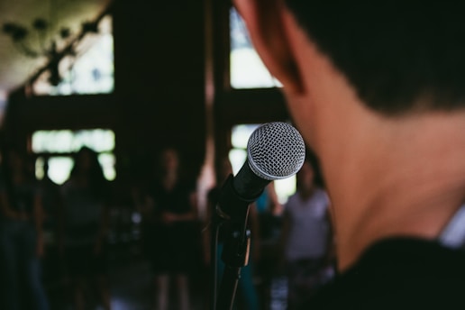 man standing in front of microphone