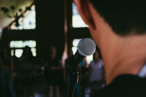 man standing in front of microphone