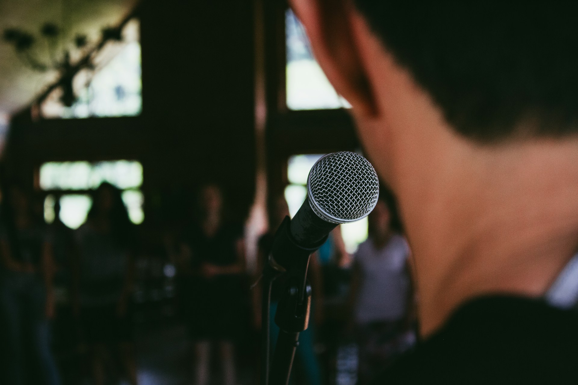 man standing in front of microphone
