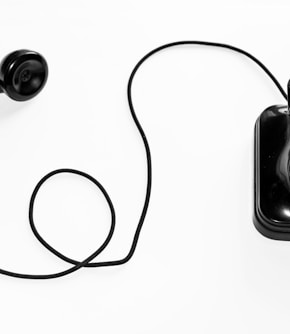 photo of black rotary phone against white background