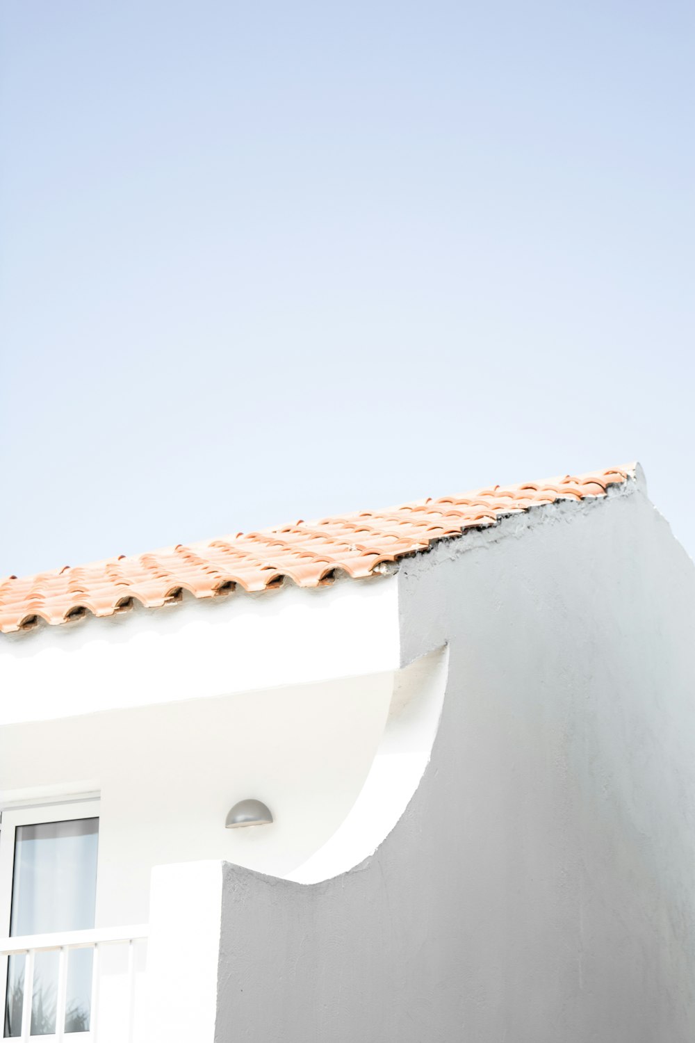 a cat sitting on the roof of a building