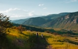 boy and man walking on mountain hill
