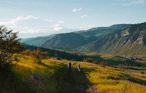 boy and man walking on mountain hill