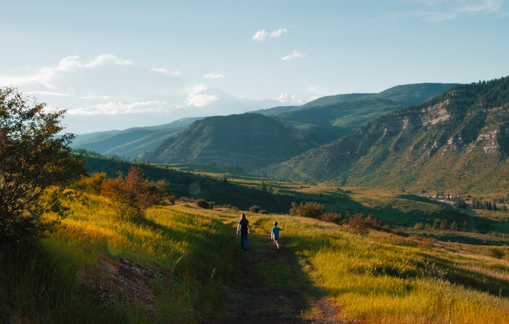 boy and man walking on mountain hill