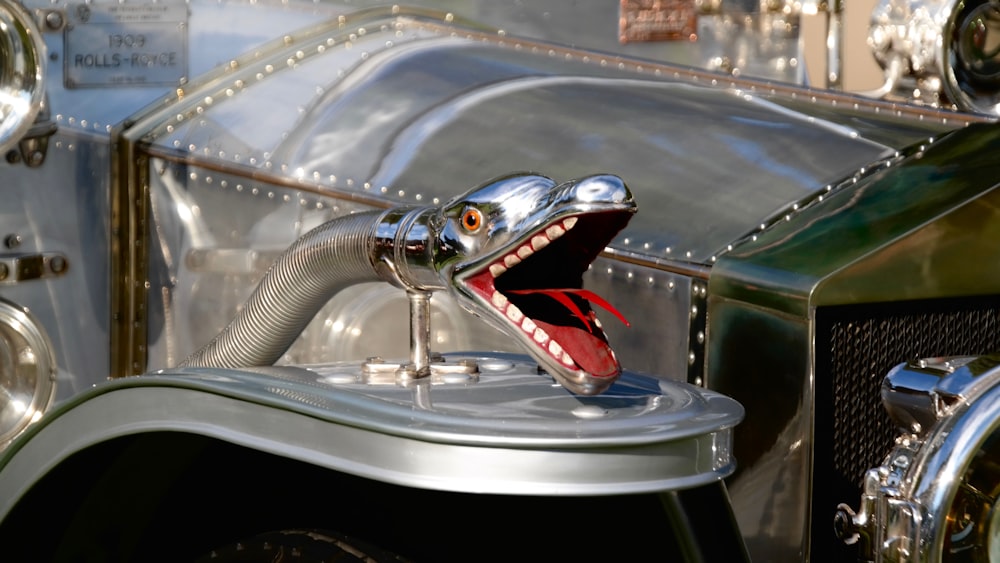 A metal snake with red tongue, mouth and detailed teeth.