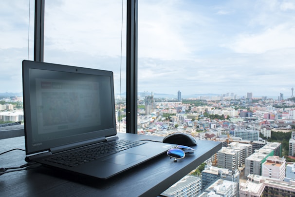 A laptop open with a vibrant screen showcasing a cityscape.
