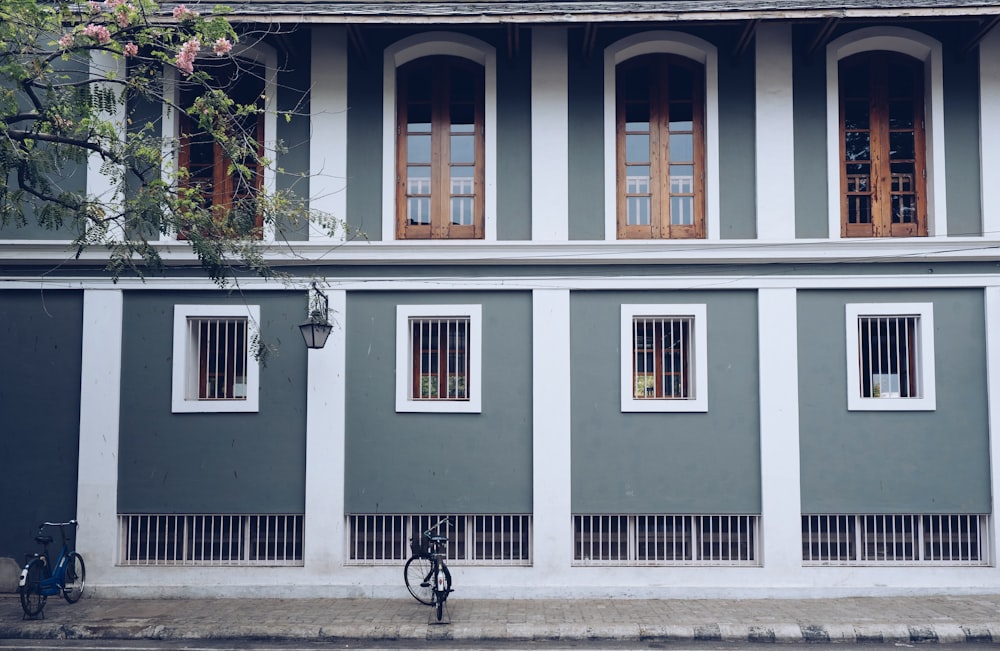 bike parked in front of gray house