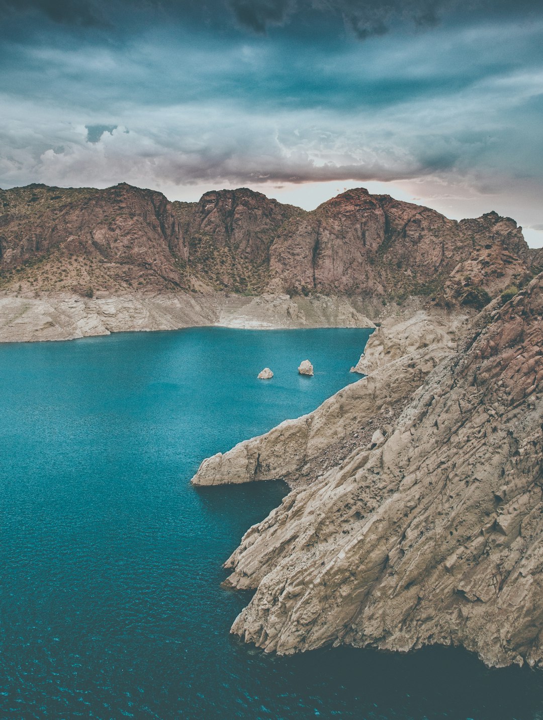 birds eye view of body of water surrounded with rocky mountain