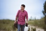 man carrying bag walking on street